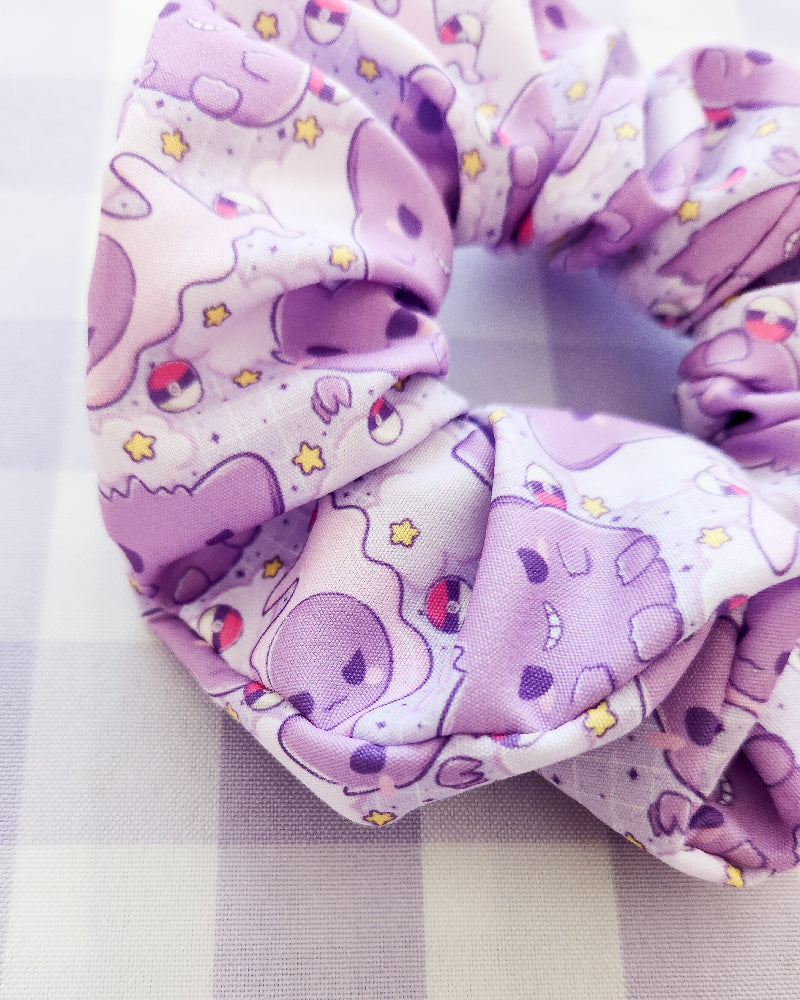 Purple fabric with cartoon character pattern on a checkered background