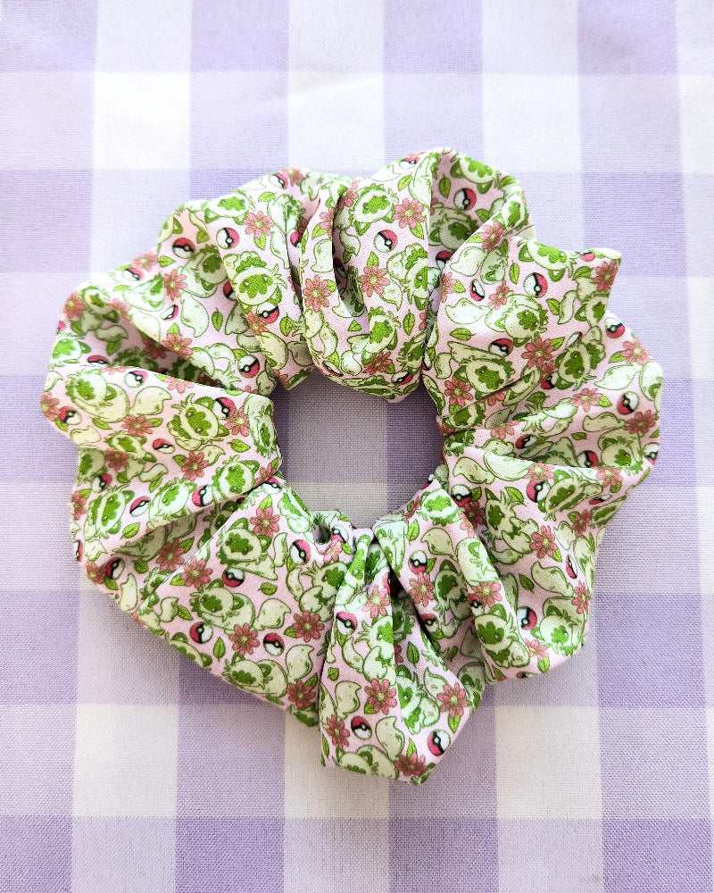 Floral patterned scrunchie on a purple and white checkered background