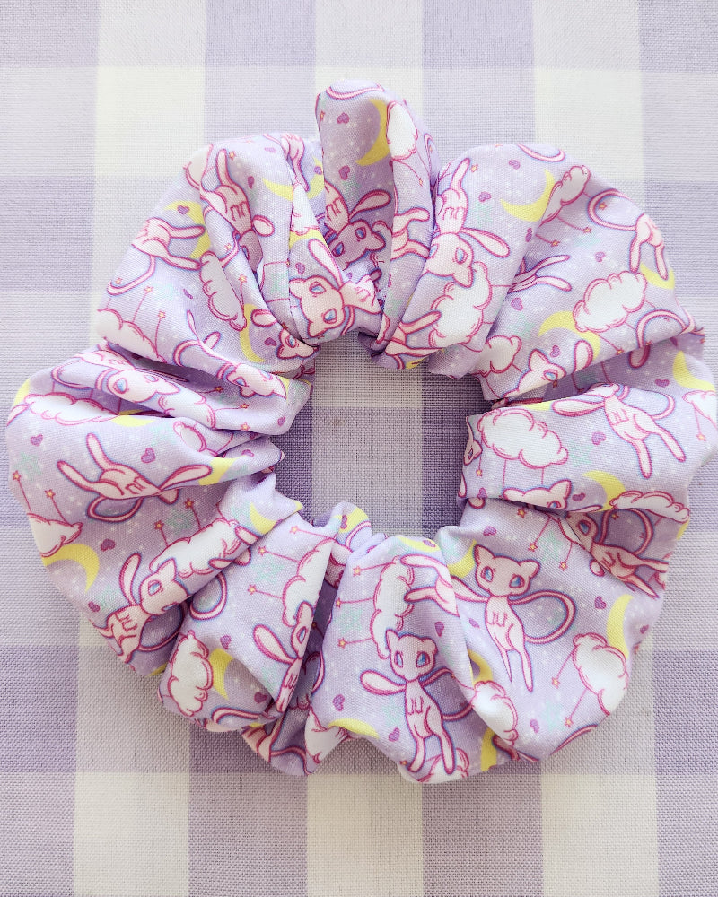 Pink scrunchie with cartoon designs on a checkered background