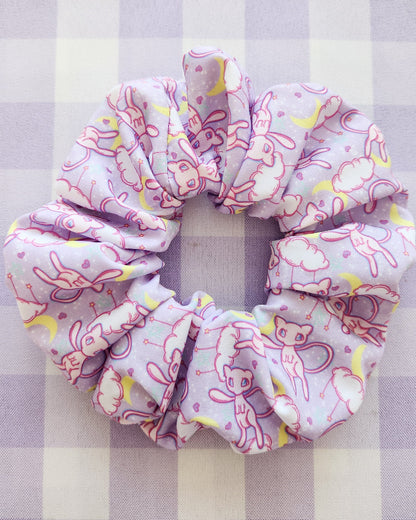 Pink scrunchie with cartoon designs on a checkered background