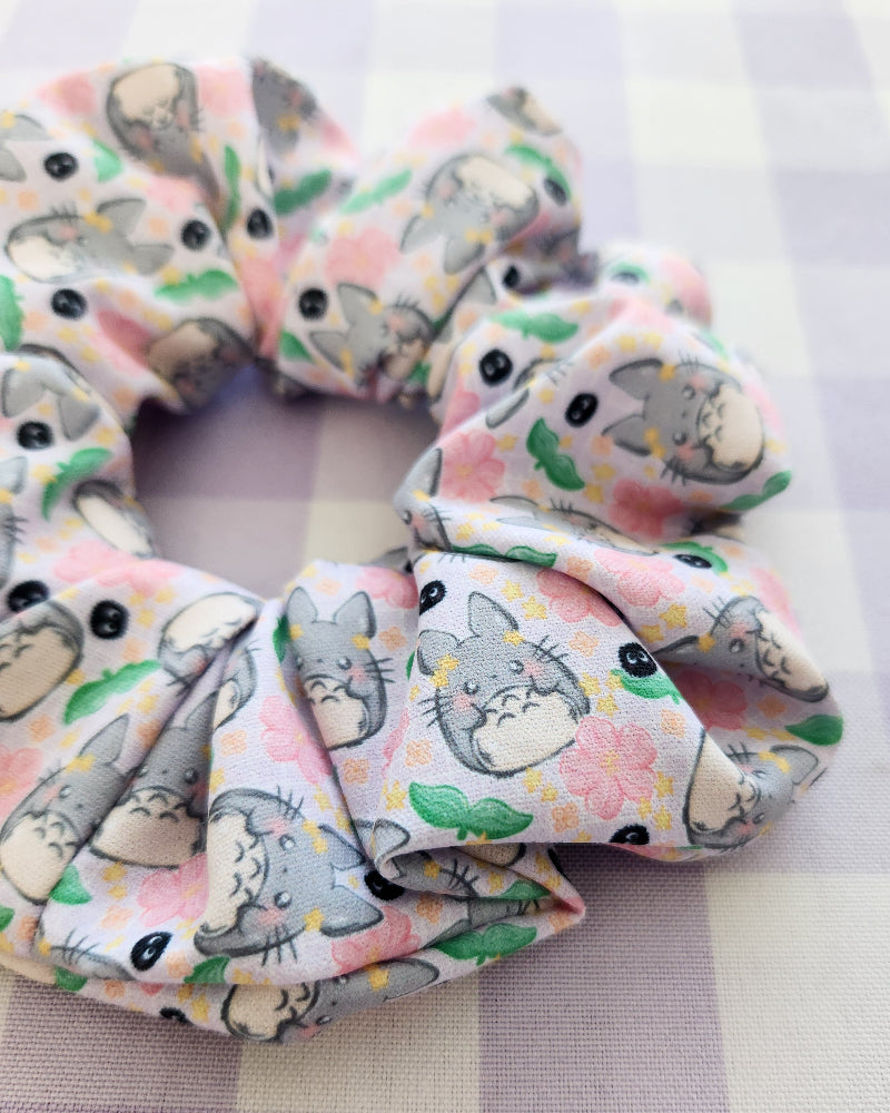 Set of scrunchies with cartoon character design on a checkered fabric background
