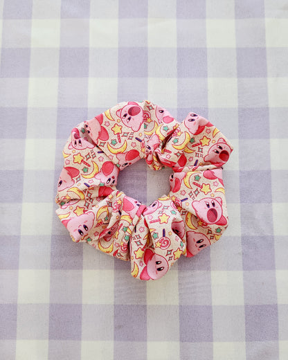 Colorful scrunchie with cartoon character design on a purple and white checkered background